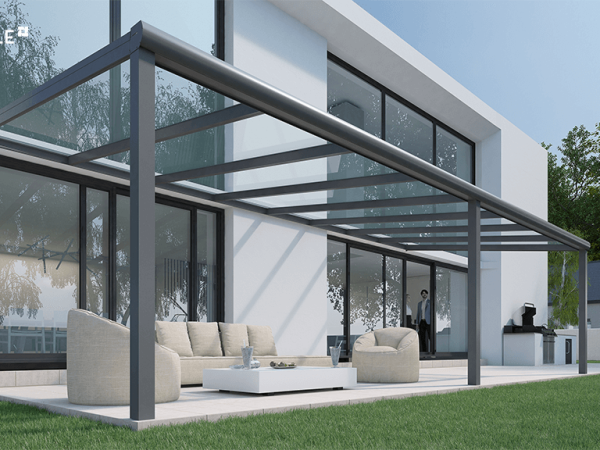 A pergola with white furniture.
